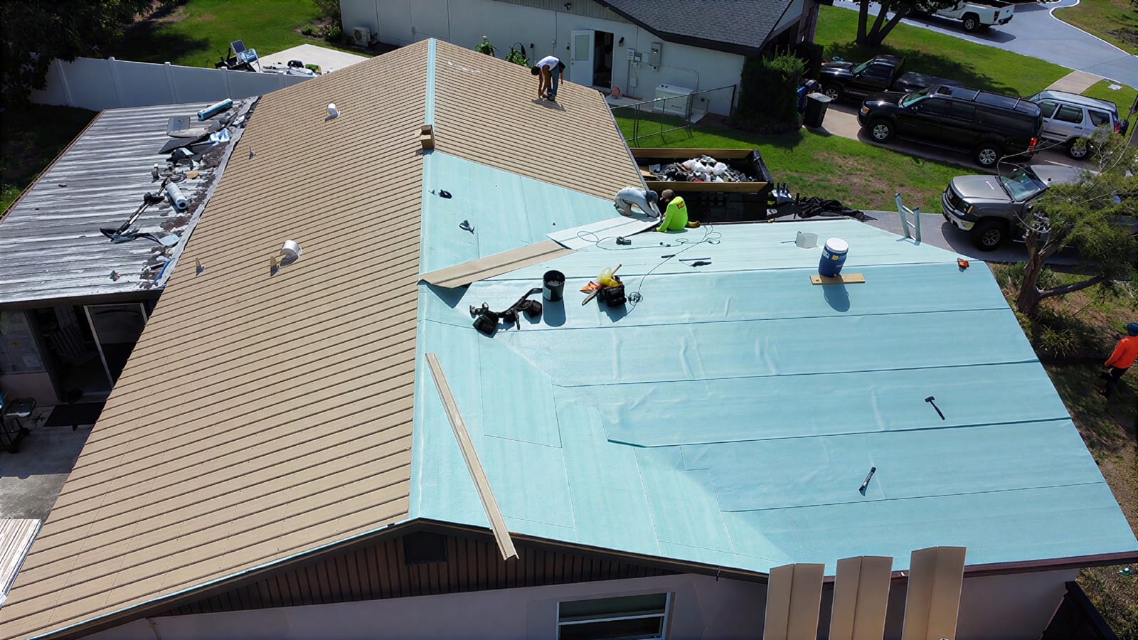 Integrity Roofing of Florida crew replacing a roof with new metal panels in Tampa Bay